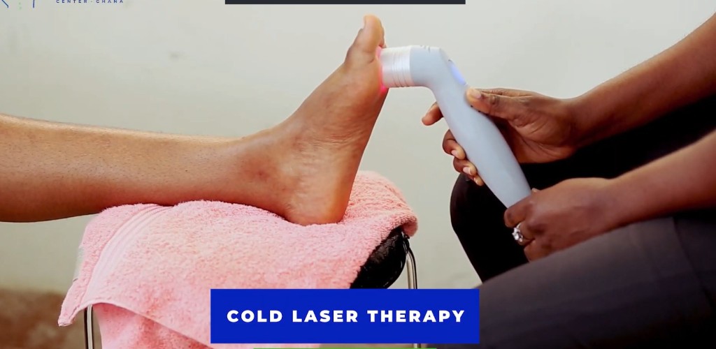 Cold laser therapy applied to a patient&rsquo;s foot at Spine and Nerve Center Ghana